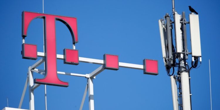 FILE PHOTO: A crow rests on the GSM mobile phone antennas of Deutsche Telekom AG atop the German telecoms giant's headquarters in Bonn, Germany, February 19, 2019. REUTERS/Wolfgang Rattay/File Photo